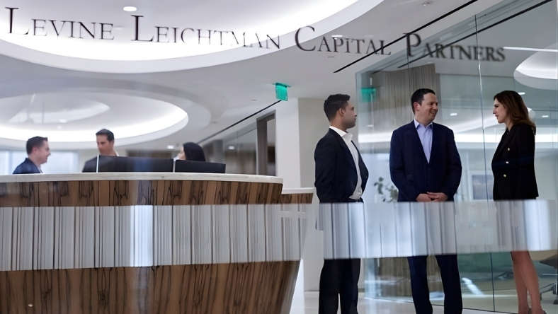 Executives in conversation inside a modern corporate office