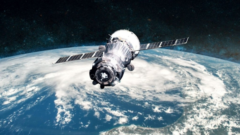 Earth observation satellite orbiting above planet surface